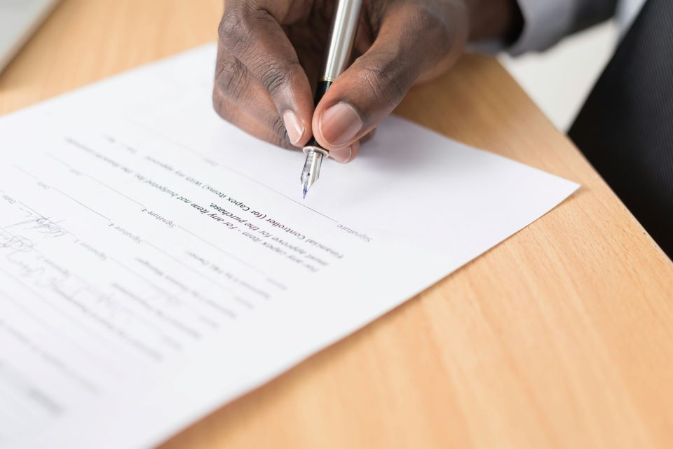 La Guía Definitiva: Cómo Proteger tu Alquiler Vacacional, a tus Huéspedes y a Ti Mismo 5 hombre-firma-documento